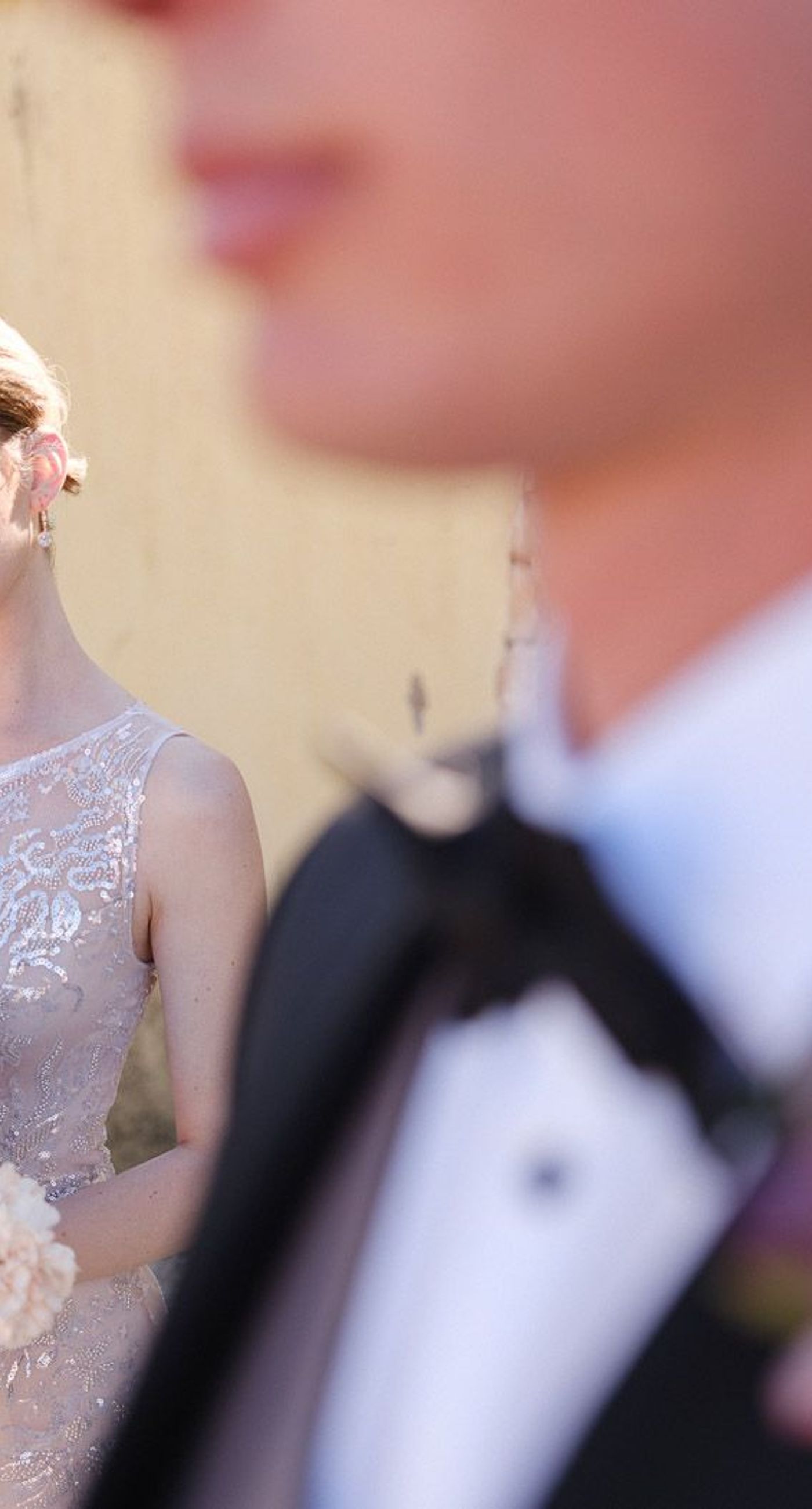 Amillia & Eriks - In this enchanting floral showcase, delicate blossoms cascade in a stunning array of pinks, purples, and deep reds, creating an ethereal backdrop for a moment of elegance and romance. The vibrant hues of the flowers stand out against the crisp white Mediterranean-style setting, evoking a sense of timeless beauty. Each bloom is meticulously arranged, showcasing the artistry and vision of bespoke floral design. The interplay of natural light dancing across the scene adds a touch of magic, ensuring that every detail invites admiration and adds to the harmonious, yet bold aesthetic. - Photo 7