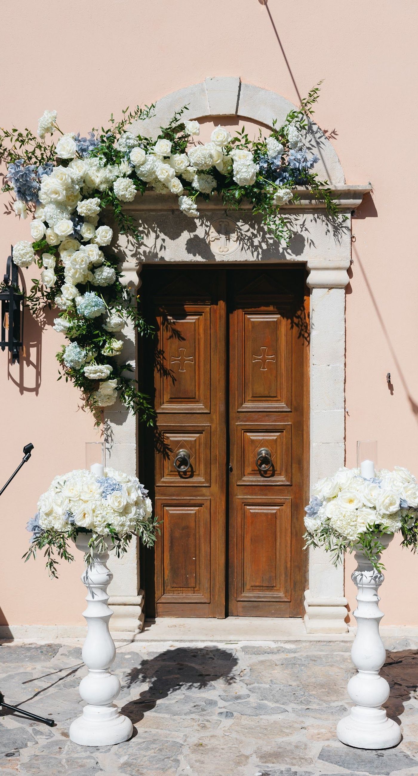 Andria & Alan - Bathed in the golden glow of a setting sun, this moment exudes an elegant blend of warmth and romance. The gentle hues of greenery and the soft embrace of light create a serene ambiance, perfectly framing the delicate embroidery of a bridal gown. The subtle interplay of shadow and light, with touches of white and green flowers, enhances the luxurious simplicity of the scene. This exquisite piece captures the essence of an enchanting outdoor celebration, where nature and elegance harmoniously unite, offering a timeless backdrop for cherished memories. - Photo 1
