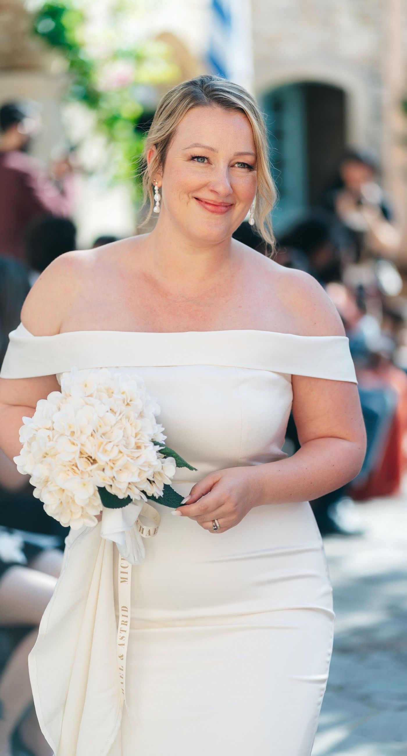 Andria & Alan - Bathed in the golden glow of a setting sun, this moment exudes an elegant blend of warmth and romance. The gentle hues of greenery and the soft embrace of light create a serene ambiance, perfectly framing the delicate embroidery of a bridal gown. The subtle interplay of shadow and light, with touches of white and green flowers, enhances the luxurious simplicity of the scene. This exquisite piece captures the essence of an enchanting outdoor celebration, where nature and elegance harmoniously unite, offering a timeless backdrop for cherished memories. - Photo 8