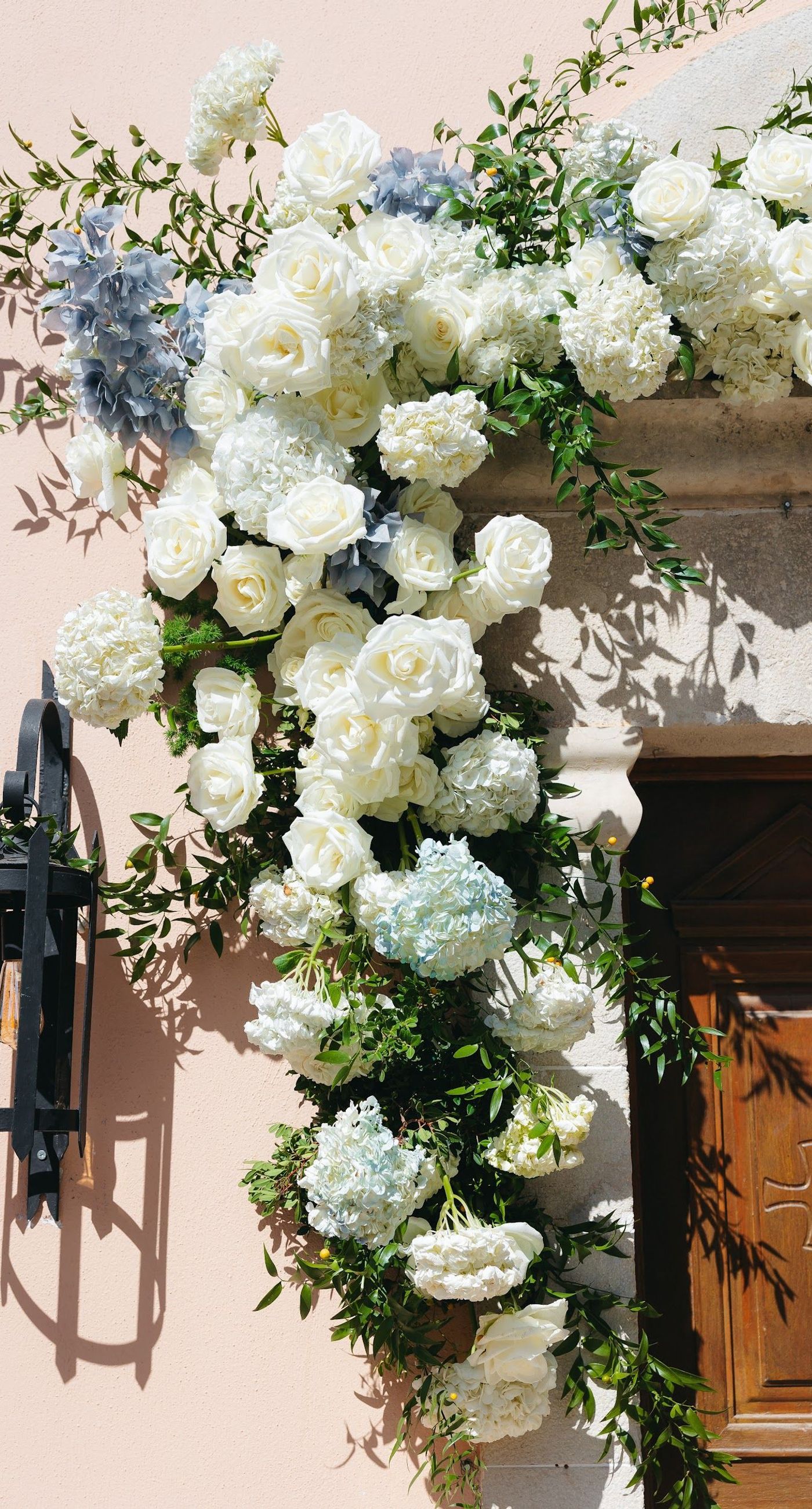 Andria & Alan - Bathed in the golden glow of a setting sun, this moment exudes an elegant blend of warmth and romance. The gentle hues of greenery and the soft embrace of light create a serene ambiance, perfectly framing the delicate embroidery of a bridal gown. The subtle interplay of shadow and light, with touches of white and green flowers, enhances the luxurious simplicity of the scene. This exquisite piece captures the essence of an enchanting outdoor celebration, where nature and elegance harmoniously unite, offering a timeless backdrop for cherished memories. - Photo 4