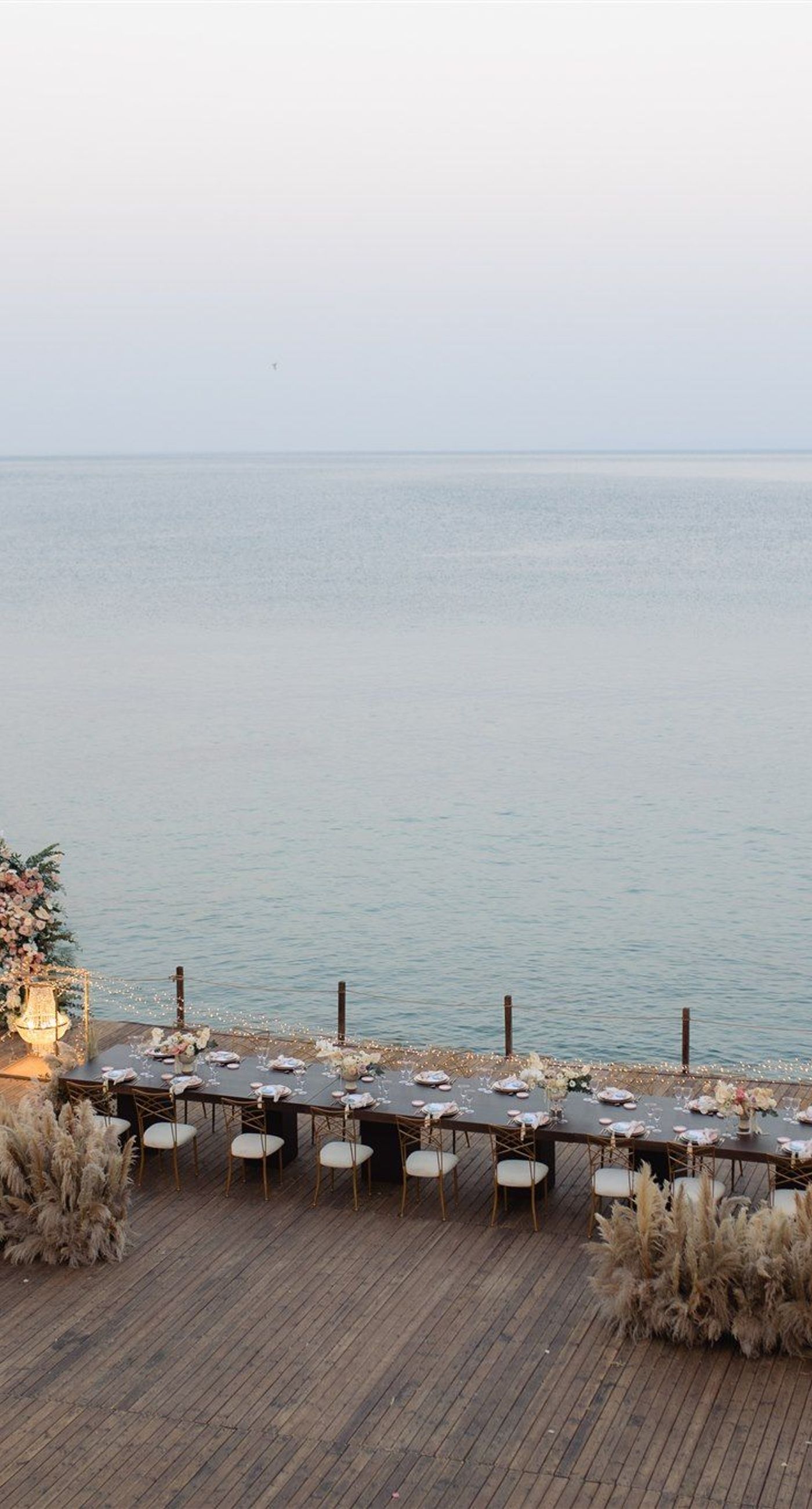 Brittany&James - In a breathtaking dance of romance and nature, the floral masterpiece unfolds with a palette of soft pastels—a delicate harmony of blush pinks, gentle creams, and lush greenery. The exquisite arrangement embraces a dreamy outdoor setting, where elegant bouquets frame a moment stolen from time. The seamless blend of natural beauty and graceful elegance creates an enchanting atmosphere, perfectly capturing the essence of love's tender embrace. This floral artistry evokes a feeling of serene sophistication, enhancing the allure of any special occasion with its timeless charm. - Photo 4