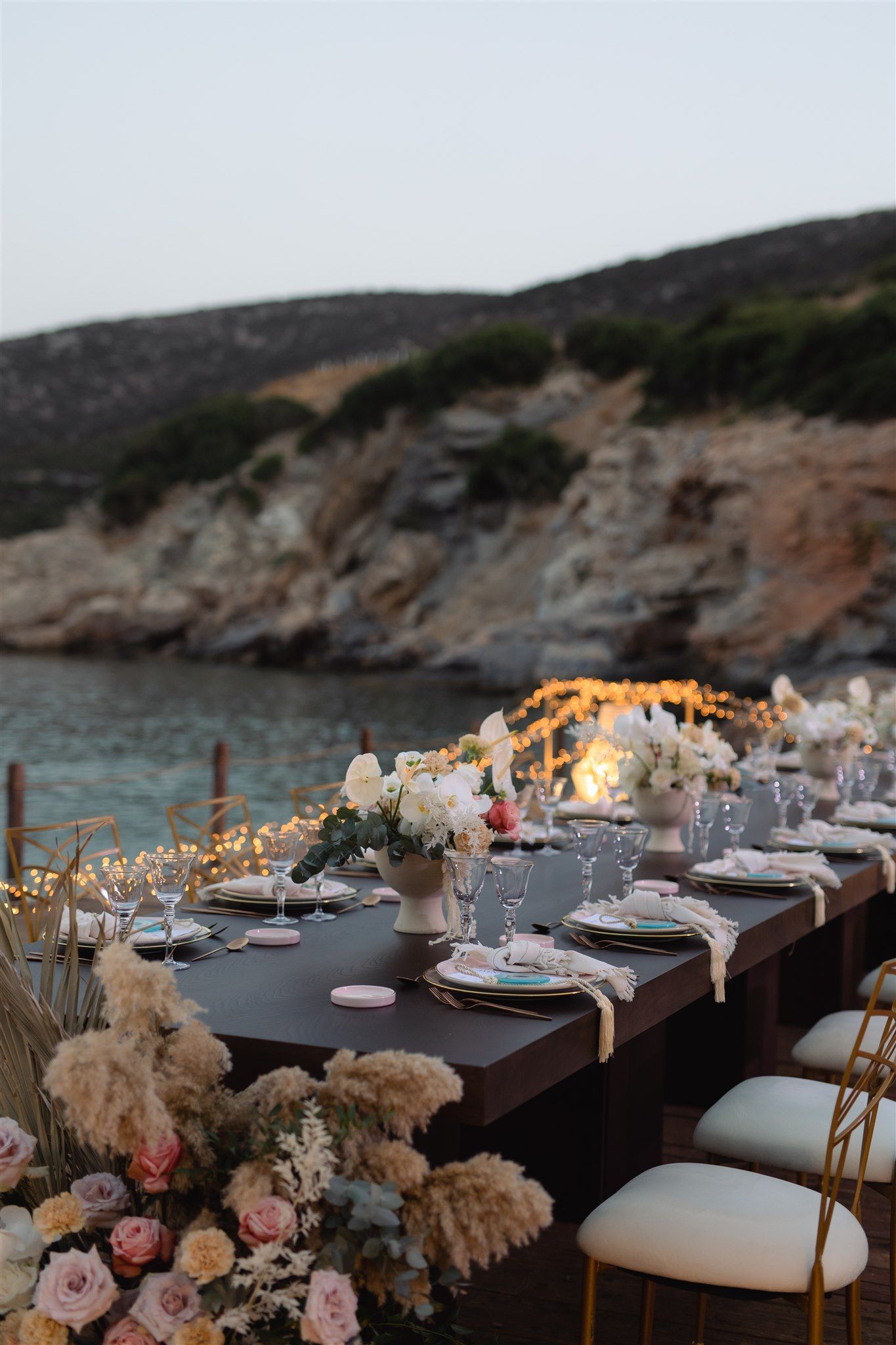 Brittany&James - In a breathtaking dance of romance and nature, the floral masterpiece unfolds with a palette of soft pastels—a delicate harmony of blush pinks, gentle creams, and lush greenery. The exquisite arrangement embraces a dreamy outdoor setting, where elegant bouquets frame a moment stolen from time. The seamless blend of natural beauty and graceful elegance creates an enchanting atmosphere, perfectly capturing the essence of love's tender embrace. This floral artistry evokes a feeling of serene sophistication, enhancing the allure of any special occasion with its timeless charm. - Photo 6
