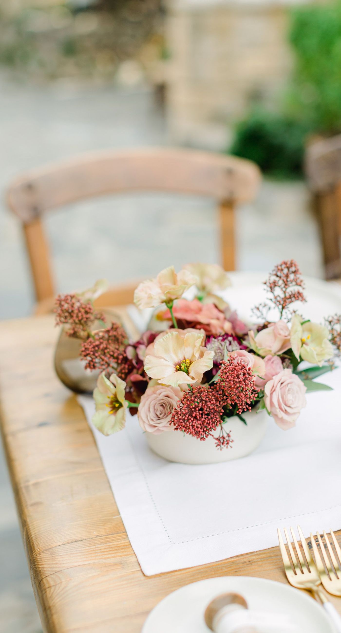 Chiara & Marco - In an elegant dance of romance and subtlety, a couple is enveloped in a moment of intimate anticipation. Their surroundings whisper of nature's abundance, while the soft, muted colors of the bouquet enhance the gentle harmony between the blue suit and white gown. The florist's artistry is evident in the meticulous arrangement of delicate blooms and verdant leaves, highlighting the signature flair for understated sophistication. This serene union of floral grace and human connection brings forth an aesthetic that is both timeless and heartwarming, ideal for a setting that celebrates love and nature in its simplest form. - Photo 6