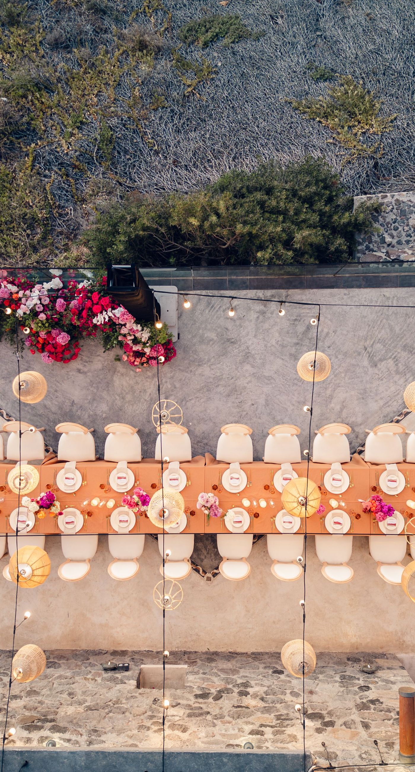 Chris & Jazmin - In a dreamlike setting beneath the soft embrace of the sun, this captivating work embodies a perfect union of elegance and romance. The delicate lace of her gown interlaces with the tender embrace of her partner, creating an ethereal atmosphere amidst the tranquil architecture. A vibrant bouquet bursts with life, featuring an exquisite medley of fuchsia, orange, and deep crimson blooms, each petal whispering tales of timeless love. The muted tones of the setting contrast beautifully with the vivid flowers, offering a glimpse into a serene world where artistry and nature harmonize flawlessly. This presentation speaks to the profound beauty that can blossom in moments of connection. - Photo 13