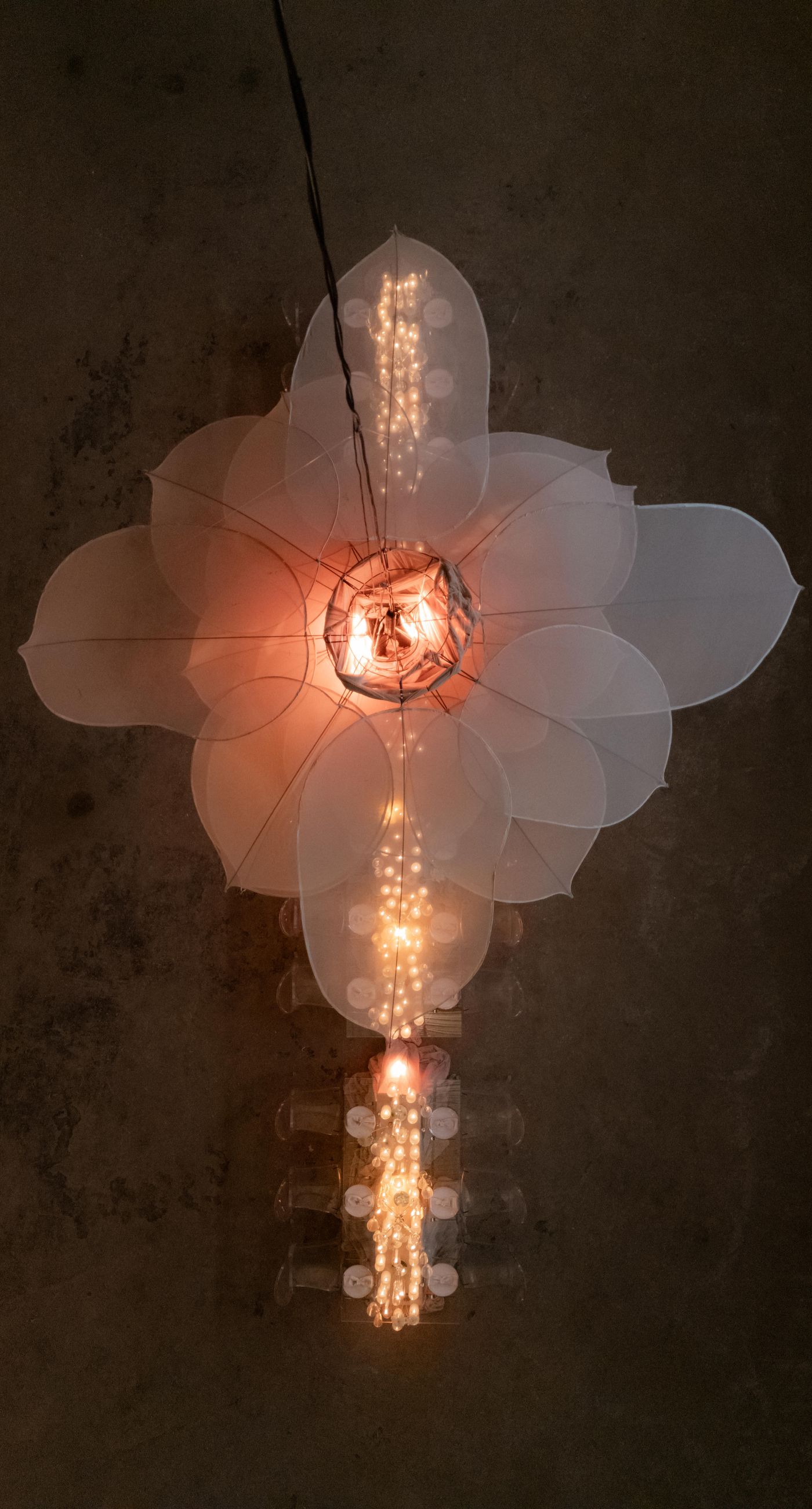 The Extravaganza Flower - Set within an industrial space, this project was conceived as an atmospheric dining experience where light and form take center stage. A sculptural, suspended installation “blooms” above the table, creating depth and scenography, while a candlelit setup adds warmth and intimacy. Clean lines, transparent materials, and subtle florals complete a design that goes beyond decoration it is installation art with emotion. - Photo 9