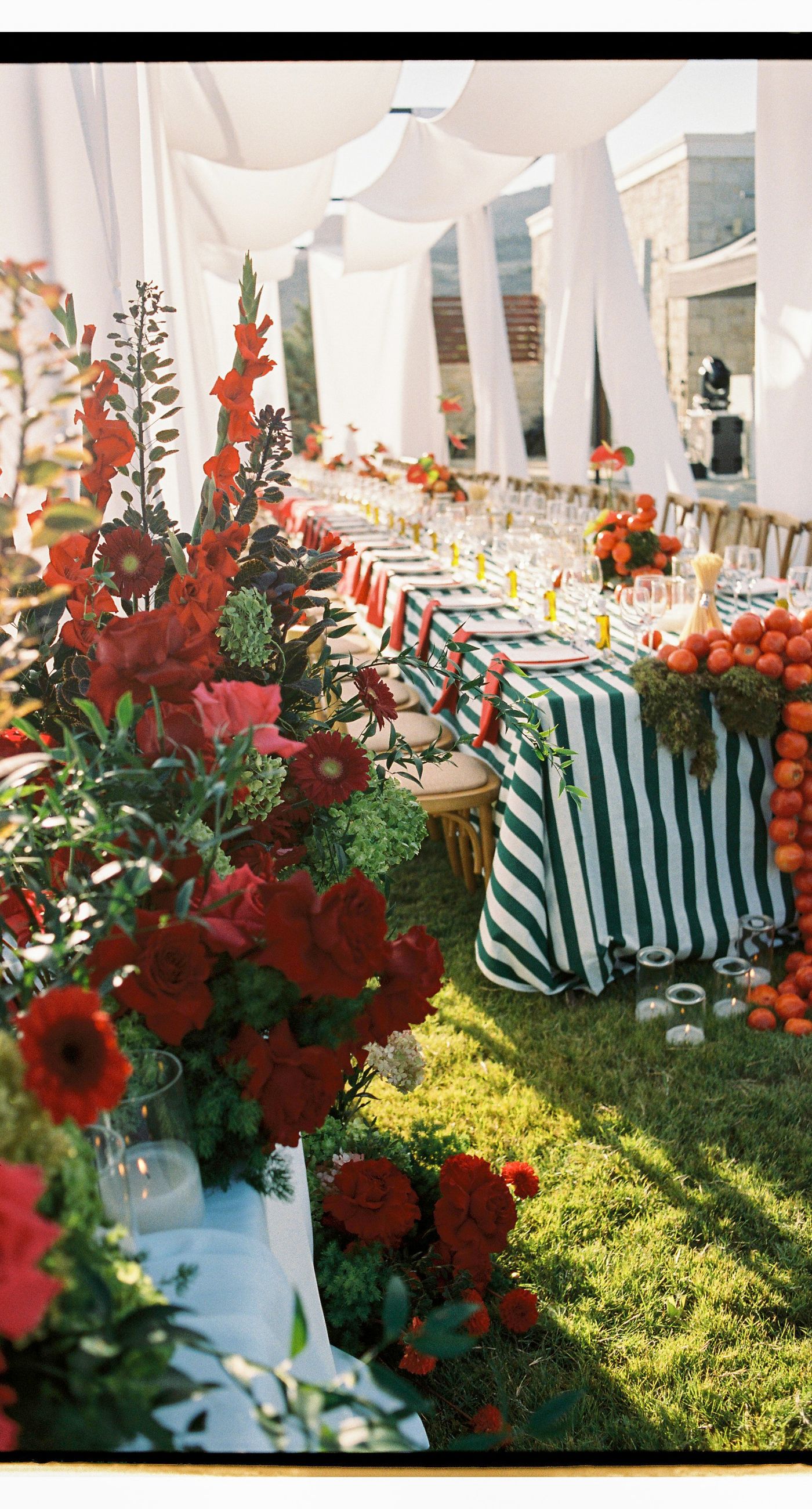 Garden Ceremony - A complete wedding experience designed with a focus on color, flow, and a strong sense of place. The ceremony is framed by vibrant florals in warm tones, creating a natural and expressive setting for the couple. The dinner that follows is defined by long tables, rhythmic textiles, and unexpected details that introduce a sense of playful elegance. A project that balances structure and ease, designed to feel authentic and experienced without effort. - Photo 11