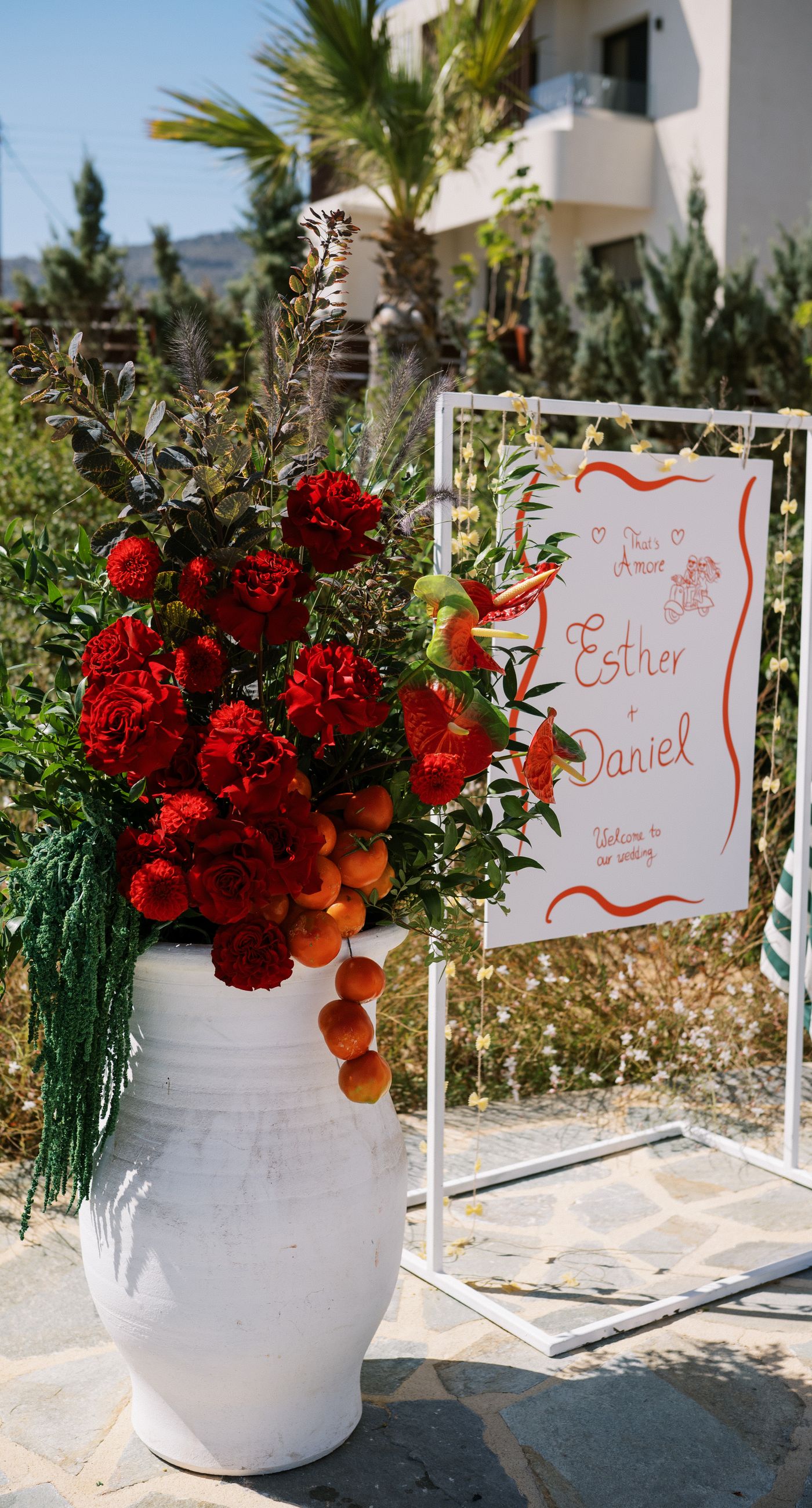 Garden Ceremony - A complete wedding experience designed with a focus on color, flow, and a strong sense of place. The ceremony is framed by vibrant florals in warm tones, creating a natural and expressive setting for the couple. The dinner that follows is defined by long tables, rhythmic textiles, and unexpected details that introduce a sense of playful elegance. A project that balances structure and ease, designed to feel authentic and experienced without effort. - Photo 13