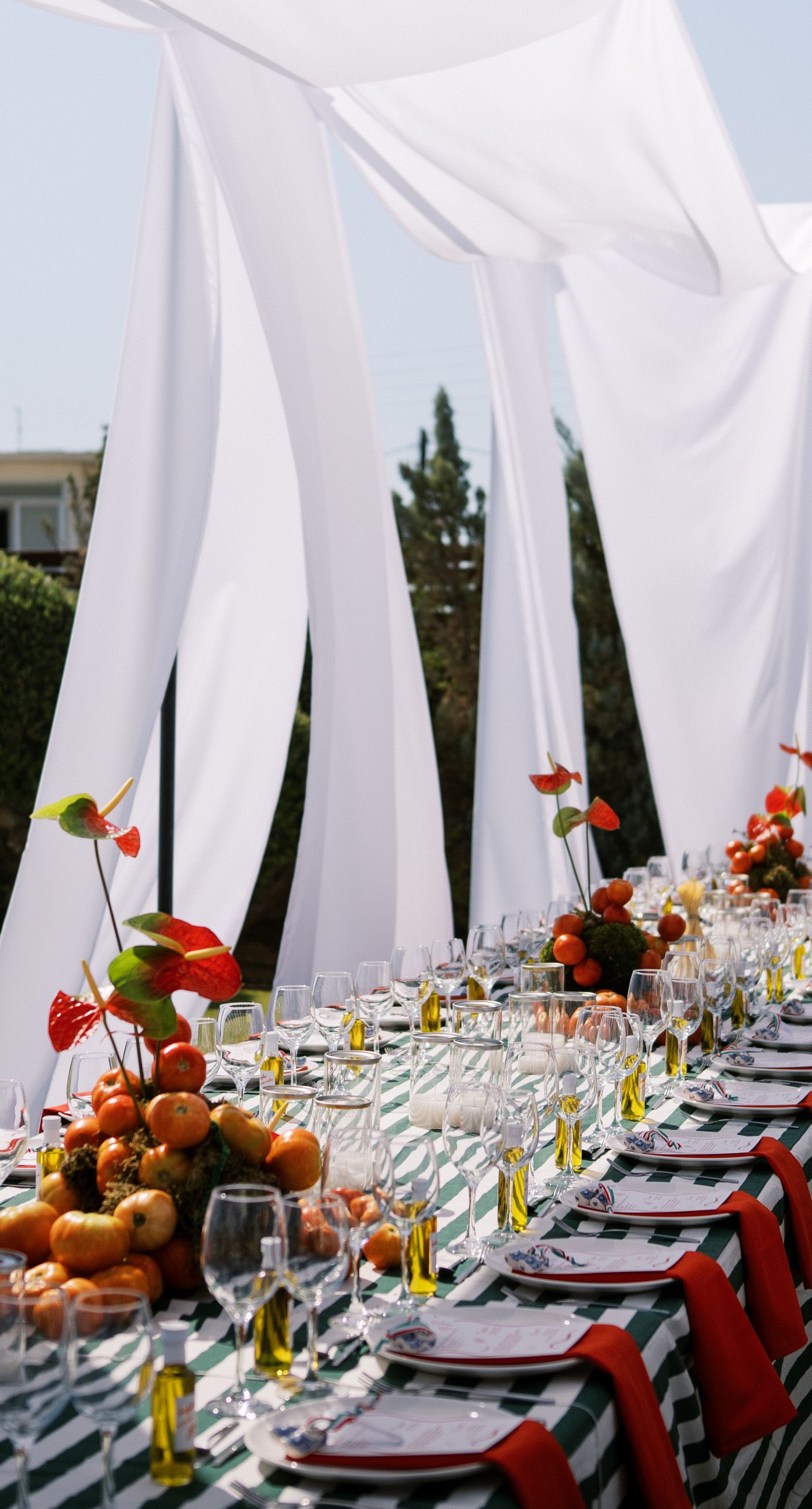 Garden Ceremony - A complete wedding experience designed with a focus on color, flow, and a strong sense of place. The ceremony is framed by vibrant florals in warm tones, creating a natural and expressive setting for the couple. The dinner that follows is defined by long tables, rhythmic textiles, and unexpected details that introduce a sense of playful elegance. A project that balances structure and ease, designed to feel authentic and experienced without effort. - Photo 18