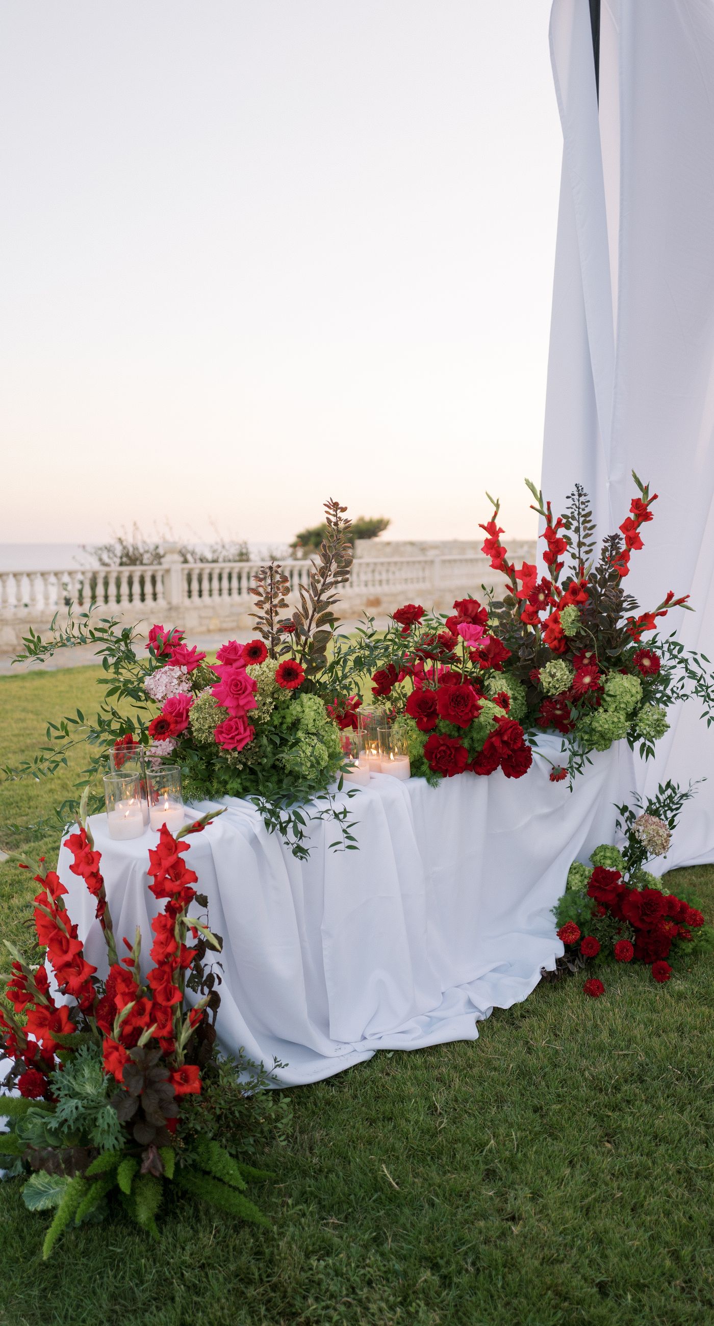 Garden Ceremony - A complete wedding experience designed with a focus on color, flow, and a strong sense of place. The ceremony is framed by vibrant florals in warm tones, creating a natural and expressive setting for the couple. The dinner that follows is defined by long tables, rhythmic textiles, and unexpected details that introduce a sense of playful elegance. A project that balances structure and ease, designed to feel authentic and experienced without effort. - Photo 17