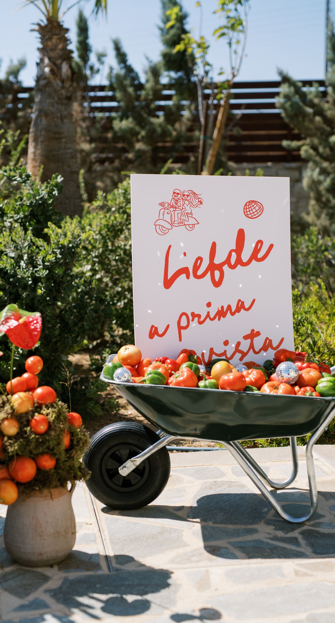 Garden Ceremony - A complete wedding experience designed with a focus on color, flow, and a strong sense of place. The ceremony is framed by vibrant florals in warm tones, creating a natural and expressive setting for the couple. The dinner that follows is defined by long tables, rhythmic textiles, and unexpected details that introduce a sense of playful elegance. A project that balances structure and ease, designed to feel authentic and experienced without effort. - Photo 12