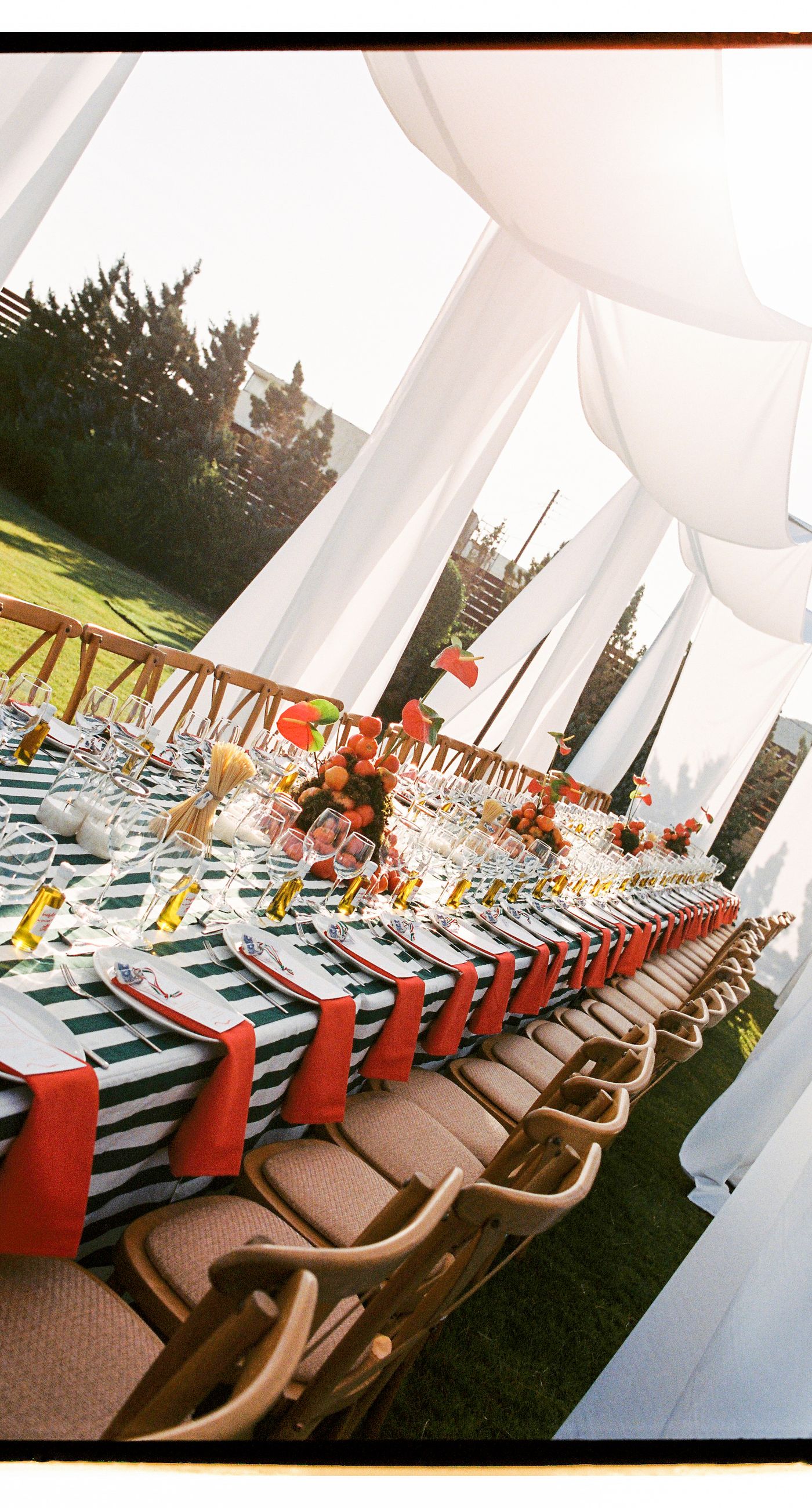 Garden Ceremony - A complete wedding experience designed with a focus on color, flow, and a strong sense of place. The ceremony is framed by vibrant florals in warm tones, creating a natural and expressive setting for the couple. The dinner that follows is defined by long tables, rhythmic textiles, and unexpected details that introduce a sense of playful elegance. A project that balances structure and ease, designed to feel authentic and experienced without effort. - Photo 13