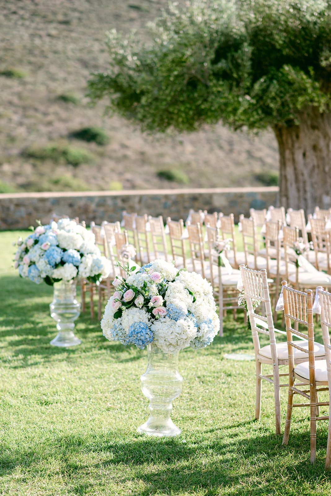 Georges&Marianna - In this exquisite composition, the scene is set with a timeless elegance, captured in a moment of pure joy and connection. The bride's sumptuous white gown cascades gracefully, its off-shoulder design complementing her delicate headpiece, which glimmers subtly under the soft lighting. She is juxtaposed beautifully against the groom's classic black tuxedo, a marriage of sophistication and contemporary flair. The grand marble staircase in the background adds an air of opulence, harmonizing with the earth tones of the venue's refined architecture. Their expressions of happiness, framed by muted hues and elegant lines, evoke an atmosphere of romance and understated luxury, perfect for a portfolio that celebrates life's most beautiful occasions. - Photo 6