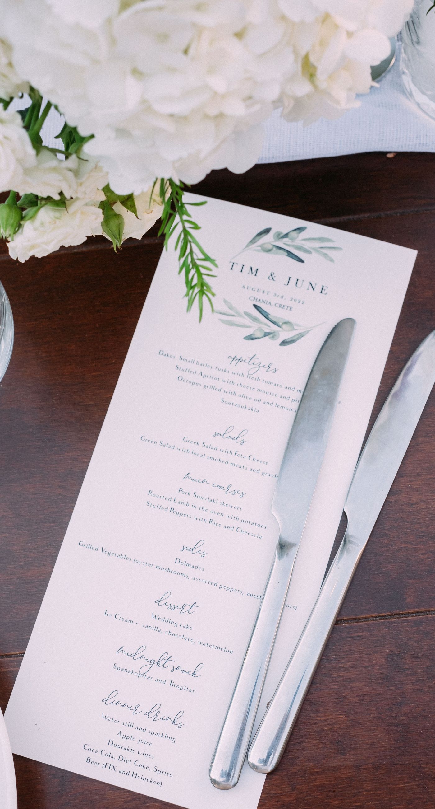 June & Tim - Beneath a lush canopy of greenery, a symphony of ivory and blush blooms cascades in a breathtaking floral arch. The delicate roses and verdant ferns intertwine effortlessly, creating a harmonious backdrop that exudes elegance and romance. The serene garden setting bathes the scene in soft, natural light, enhancing the ethereal beauty of the arrangement. The joyful expressions of the couple, captured in this radiant moment, complement the stunning florals with a vibrant energy. This captivating work reflects a masterful blend of nature's artistry and human emotion, making it an unforgettable statement in any portfolio. - Photo 8