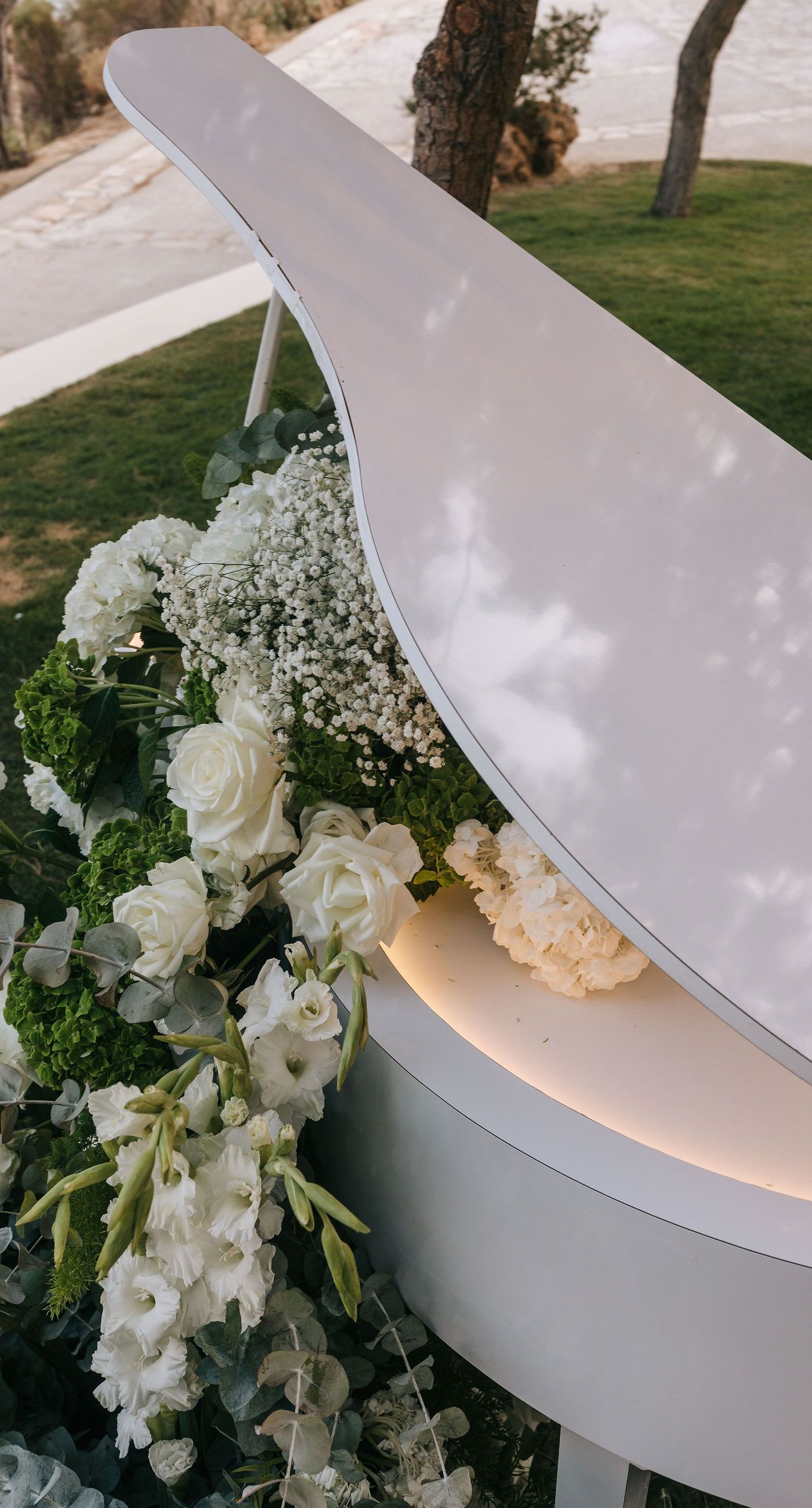 Kala & Kerwin - Bathed in the warm glow of a setting sun, the bouquet of creamy white blooms and eucalyptus whispers elegance and romance. It complements the ethereal lace details of the attire, creating a harmonious blend of textures and colors. The backdrop of rustic stone steps hints at a location where nature and romance intertwine seamlessly, offering a timeless, serene beauty. This work encapsulates a moment of profound connection and grace, emphasizing the pure emotional essence captured on a special day. - Photo 15