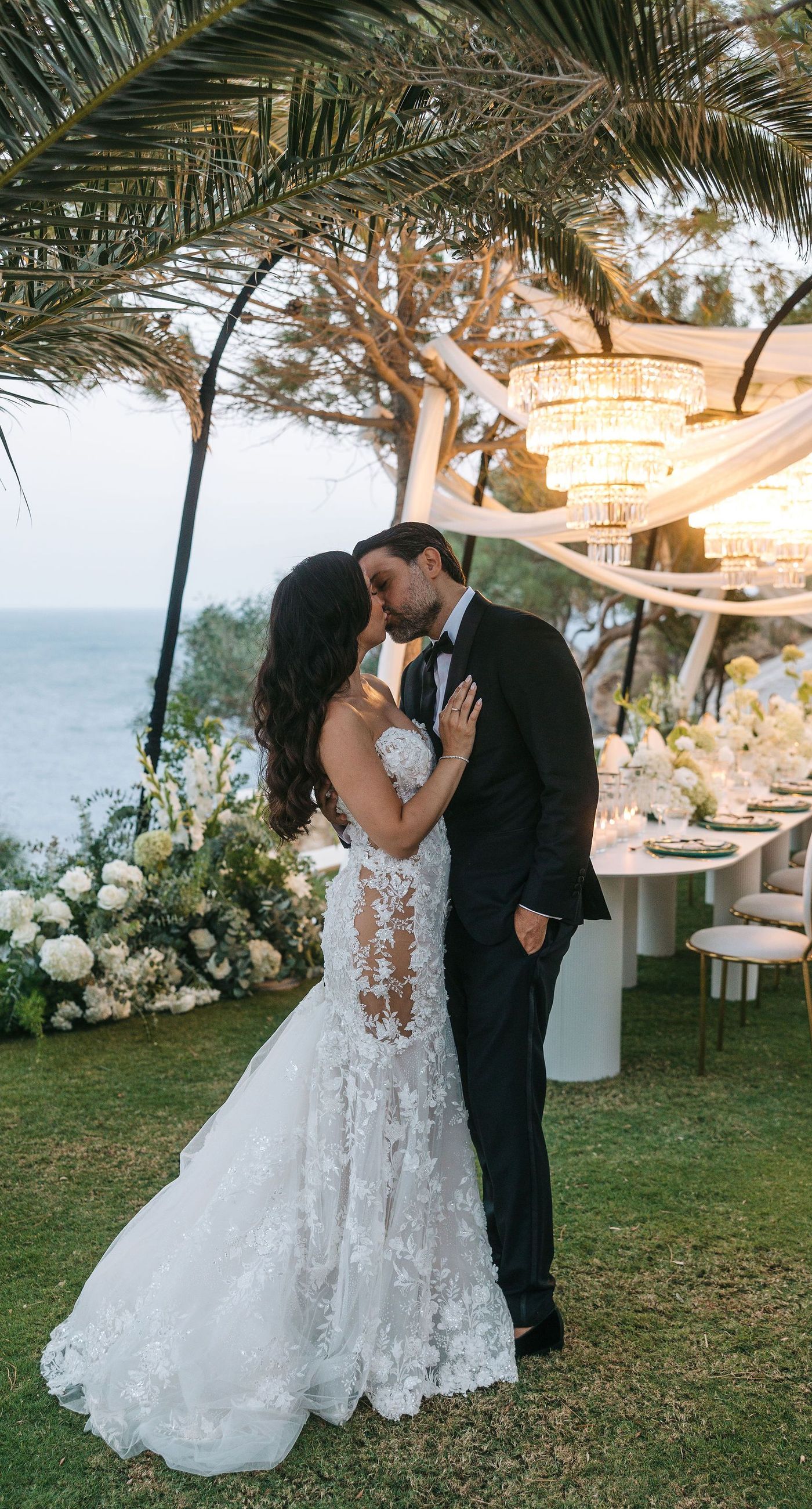 Kala & Kerwin - Bathed in the warm glow of a setting sun, the bouquet of creamy white blooms and eucalyptus whispers elegance and romance. It complements the ethereal lace details of the attire, creating a harmonious blend of textures and colors. The backdrop of rustic stone steps hints at a location where nature and romance intertwine seamlessly, offering a timeless, serene beauty. This work encapsulates a moment of profound connection and grace, emphasizing the pure emotional essence captured on a special day. - Photo 17