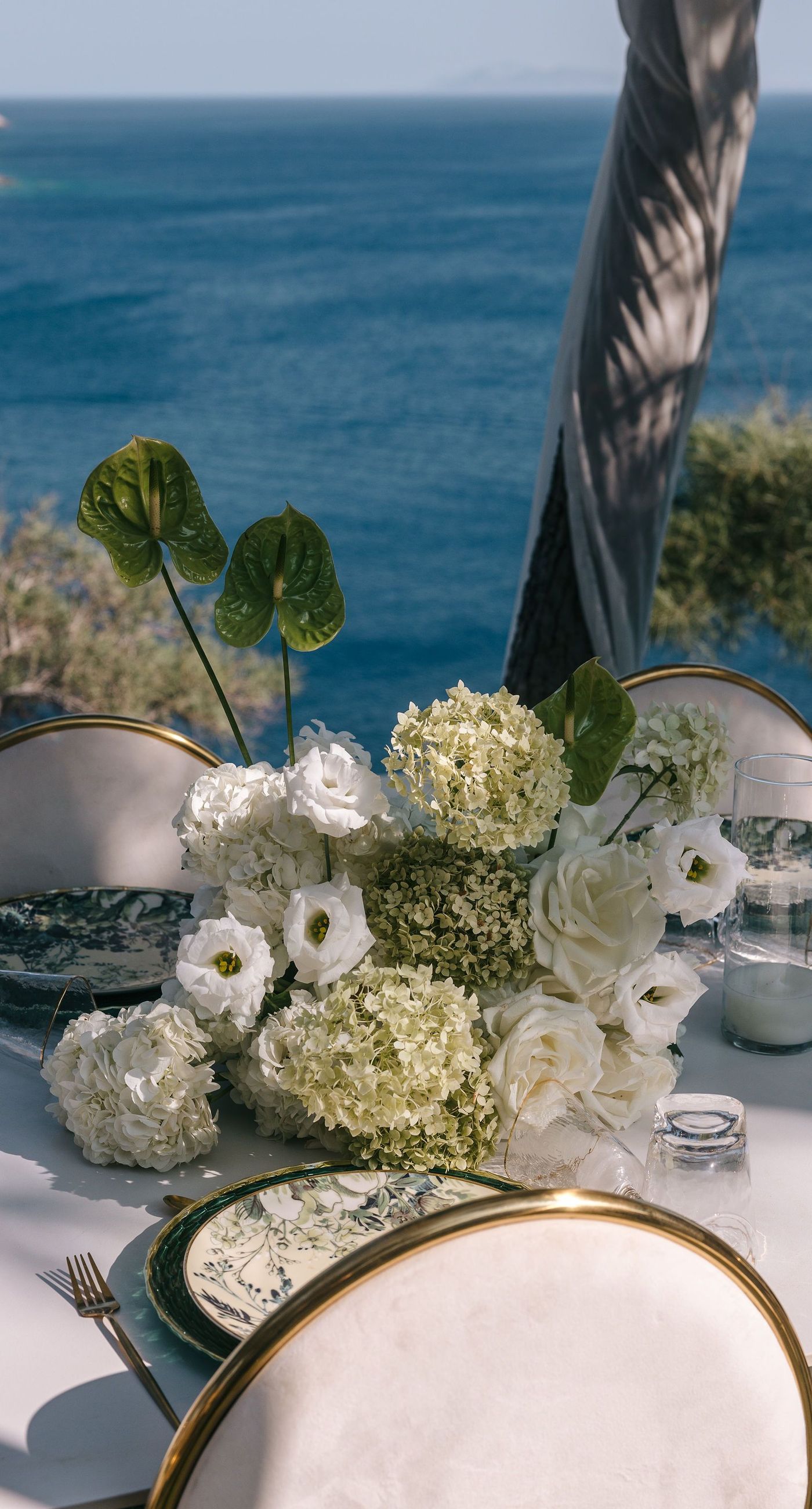 Kala & Kerwin - Bathed in the warm glow of a setting sun, the bouquet of creamy white blooms and eucalyptus whispers elegance and romance. It complements the ethereal lace details of the attire, creating a harmonious blend of textures and colors. The backdrop of rustic stone steps hints at a location where nature and romance intertwine seamlessly, offering a timeless, serene beauty. This work encapsulates a moment of profound connection and grace, emphasizing the pure emotional essence captured on a special day. - Photo 7