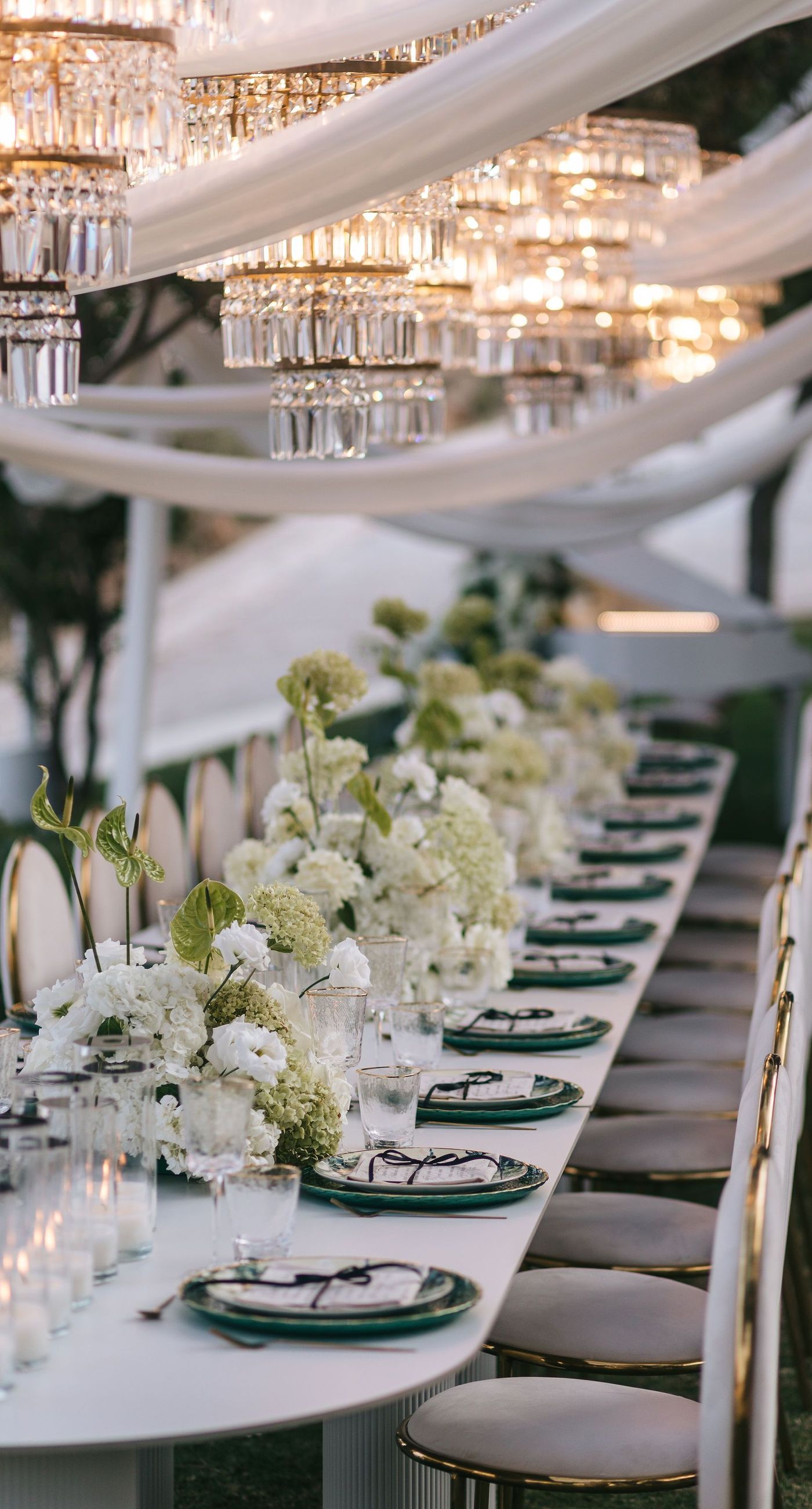 Kala & Kerwin - Bathed in the warm glow of a setting sun, the bouquet of creamy white blooms and eucalyptus whispers elegance and romance. It complements the ethereal lace details of the attire, creating a harmonious blend of textures and colors. The backdrop of rustic stone steps hints at a location where nature and romance intertwine seamlessly, offering a timeless, serene beauty. This work encapsulates a moment of profound connection and grace, emphasizing the pure emotional essence captured on a special day. - Photo 12