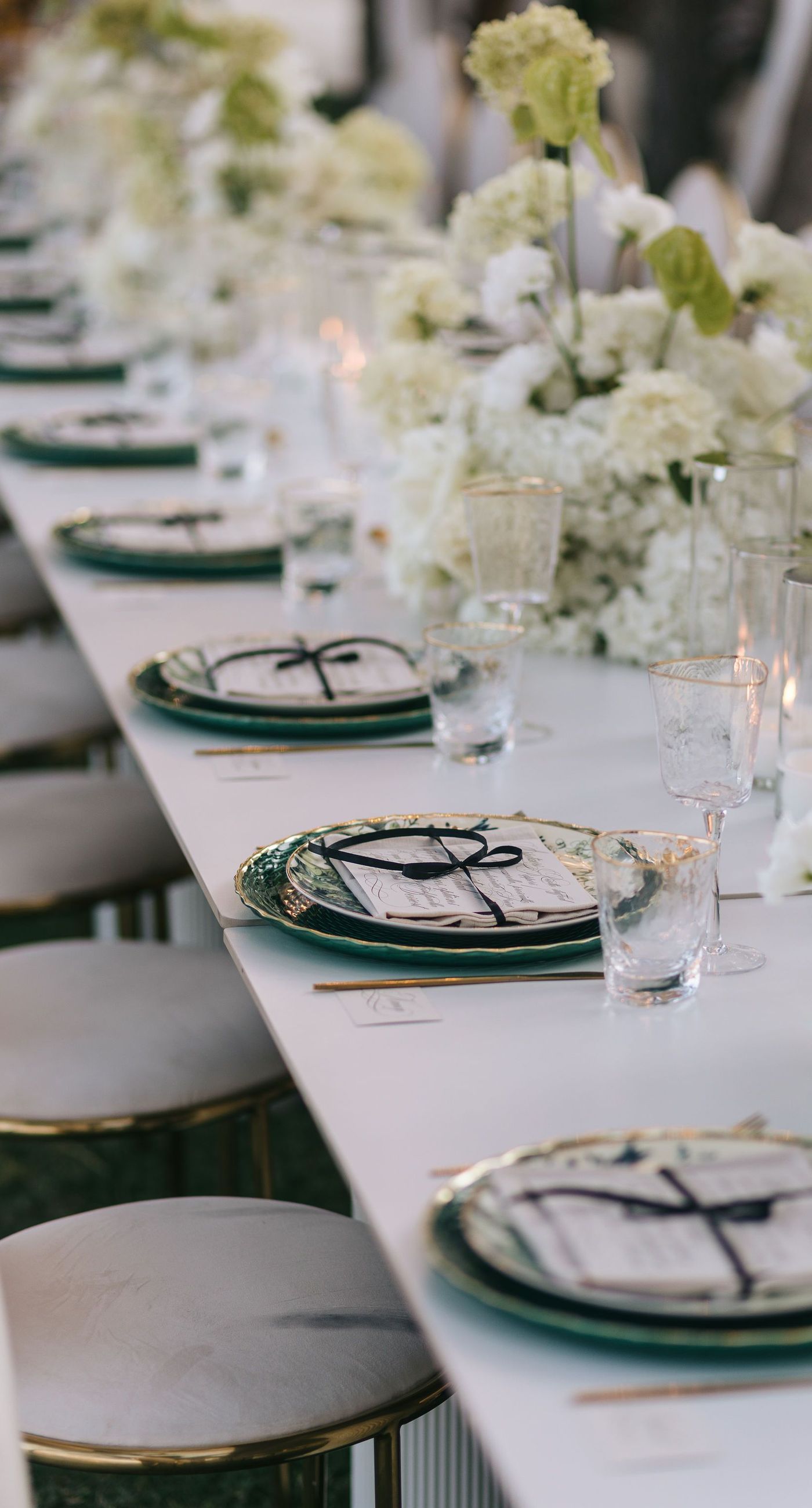 Kala & Kerwin - Bathed in the warm glow of a setting sun, the bouquet of creamy white blooms and eucalyptus whispers elegance and romance. It complements the ethereal lace details of the attire, creating a harmonious blend of textures and colors. The backdrop of rustic stone steps hints at a location where nature and romance intertwine seamlessly, offering a timeless, serene beauty. This work encapsulates a moment of profound connection and grace, emphasizing the pure emotional essence captured on a special day. - Photo 9