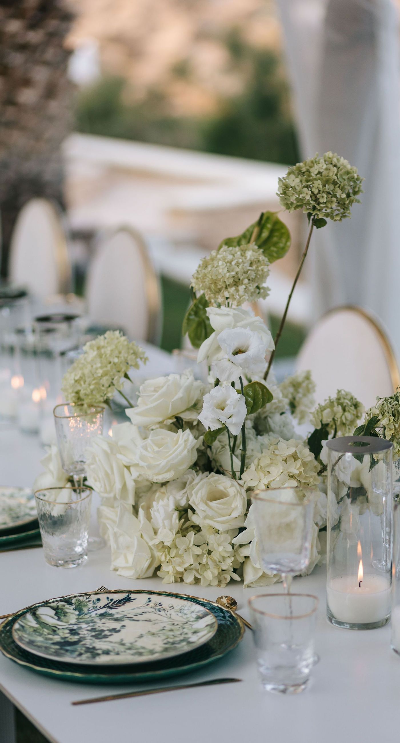 Kala & Kerwin - Bathed in the warm glow of a setting sun, the bouquet of creamy white blooms and eucalyptus whispers elegance and romance. It complements the ethereal lace details of the attire, creating a harmonious blend of textures and colors. The backdrop of rustic stone steps hints at a location where nature and romance intertwine seamlessly, offering a timeless, serene beauty. This work encapsulates a moment of profound connection and grace, emphasizing the pure emotional essence captured on a special day. - Photo 8