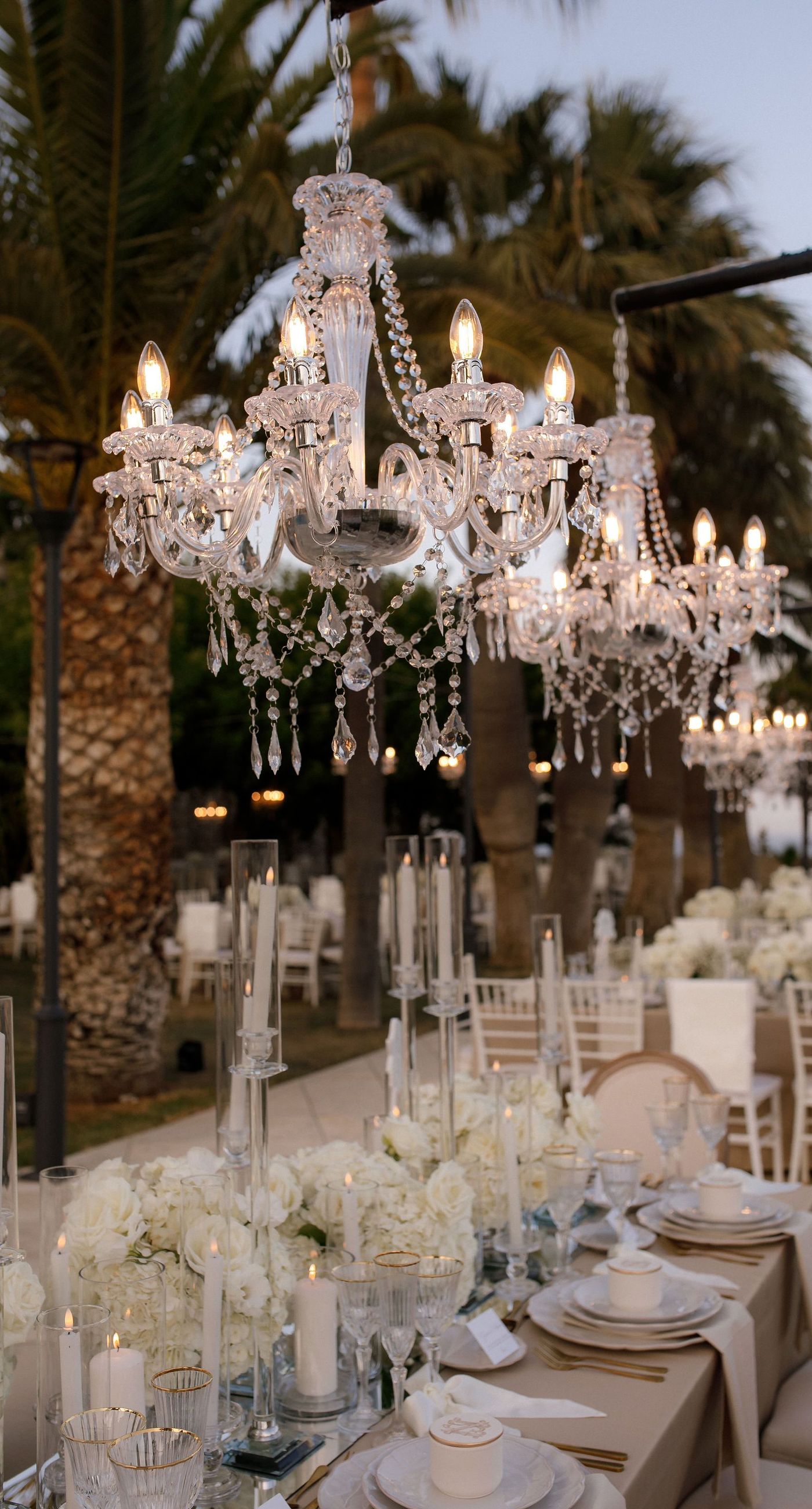 Natalia & John  - Amidst a cascade of ivory roses and lush greenery, an elegantly composed scene unfolds, embodying a timeless romance. The bride, draped in a voluminous white gown, holds a delicate bouquet of blooms that mirrors the floral splendor surrounding her. The groom, in classic black tie, complements the serene palette with a touch of timeless elegance. This artistic composition brings together the soft whispers of petals and the gentle embrace of forgotten days, creating a vibrant harmony between nature's charm and heartfelt human moments. The florals, artfully arranged, create an enchanting backdrop that speaks of new beginnings and enduring beauty. - Photo 12