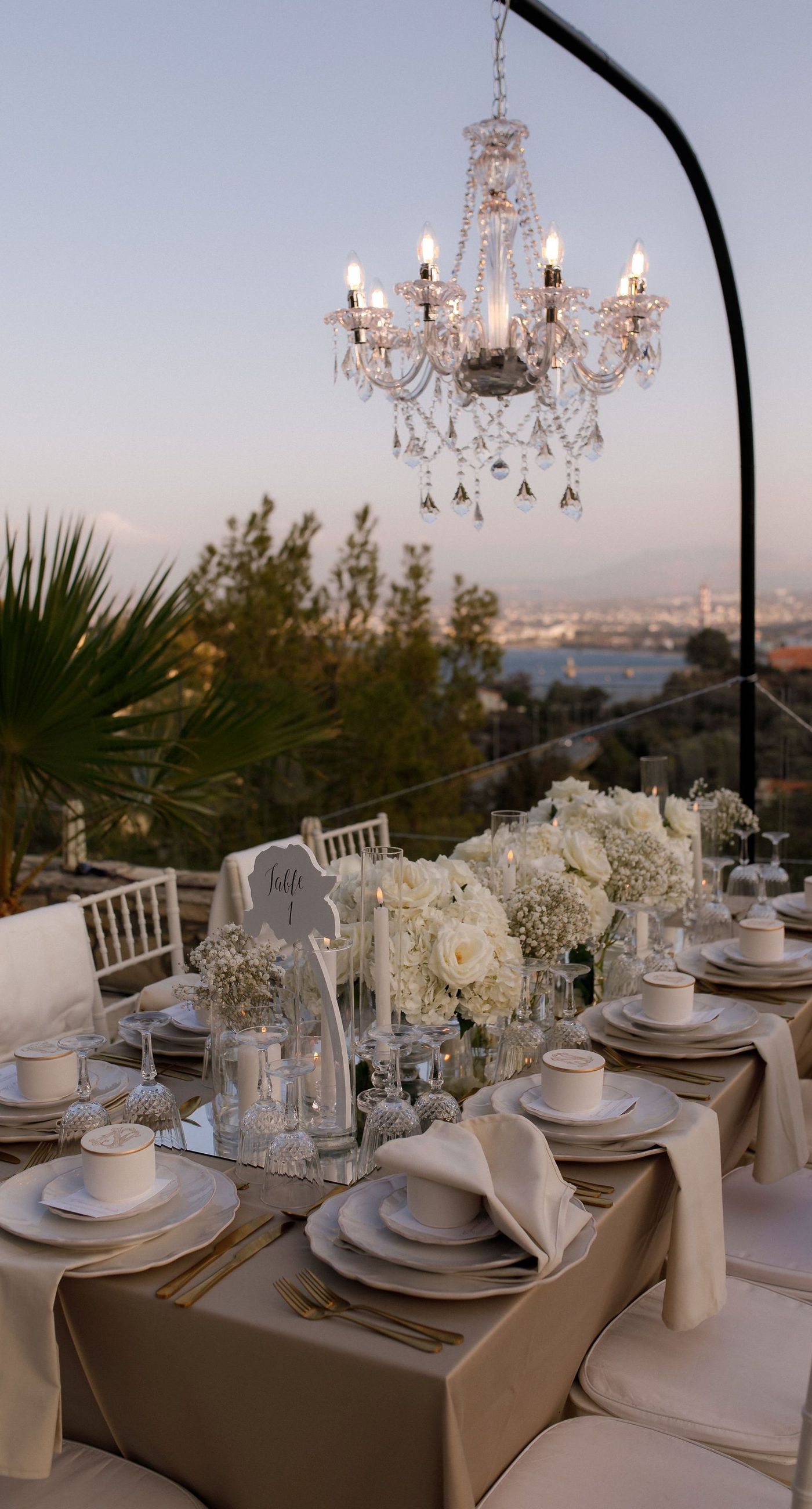 Natalia & John  - Amidst a cascade of ivory roses and lush greenery, an elegantly composed scene unfolds, embodying a timeless romance. The bride, draped in a voluminous white gown, holds a delicate bouquet of blooms that mirrors the floral splendor surrounding her. The groom, in classic black tie, complements the serene palette with a touch of timeless elegance. This artistic composition brings together the soft whispers of petals and the gentle embrace of forgotten days, creating a vibrant harmony between nature's charm and heartfelt human moments. The florals, artfully arranged, create an enchanting backdrop that speaks of new beginnings and enduring beauty. - Photo 8