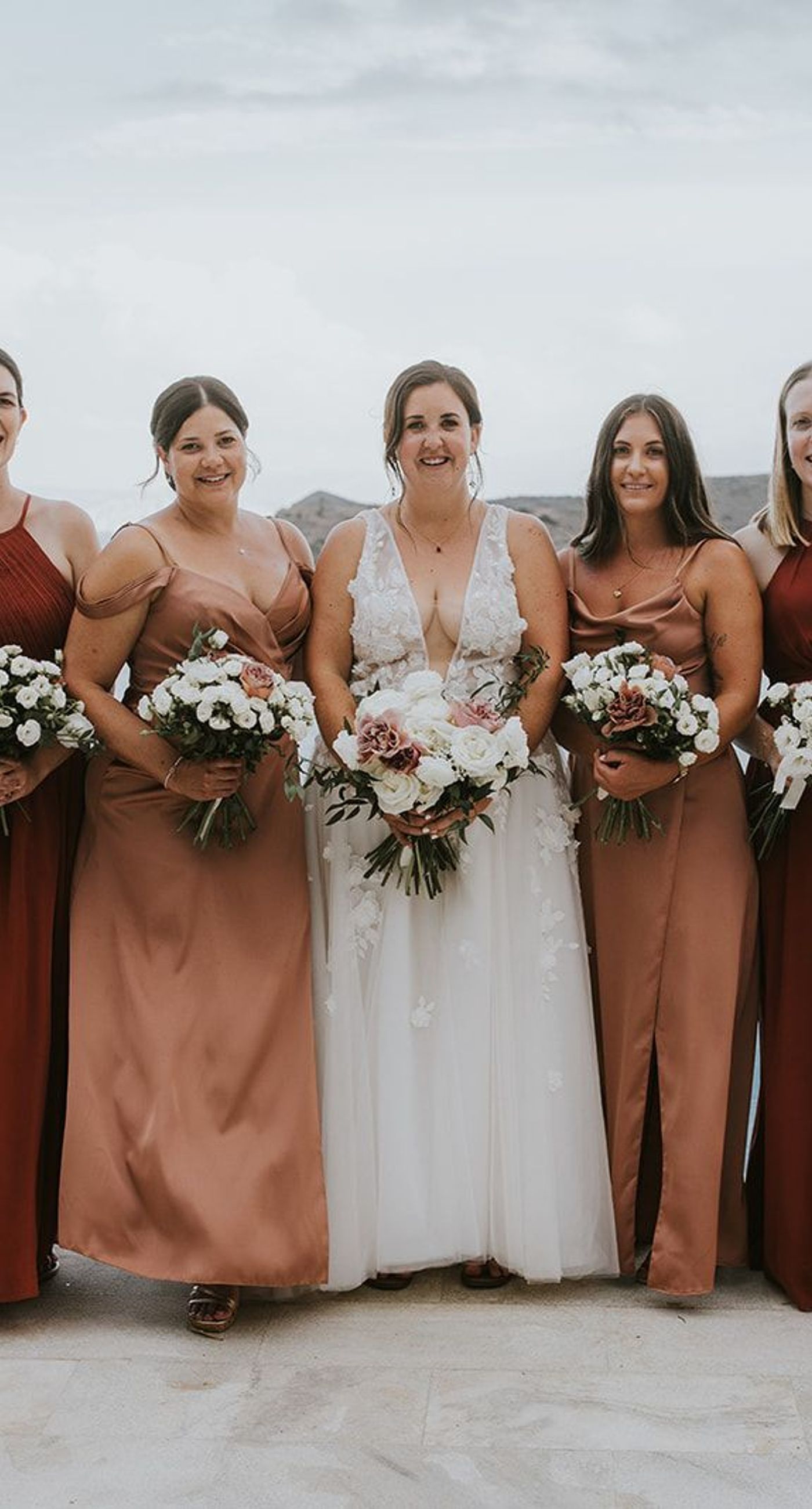 Nina& Samouel - In a beautiful symphony of nature and romance, this scene captures the essence of a perfect coastal celebration. The gentle breeze carries sweet floral whispers as the couple walks amidst a cascade of pastel petals, their smiles reflecting joy and love. The soft blues of the ocean and sky provide a serene backdrop, harmonizing with the lush greenery and delicate whites and pinks of the blooms. This composition encapsulates an idyllic, nature-infused elegance, showcasing the artistry and thoughtful design of the florist's craft. - Photo 3