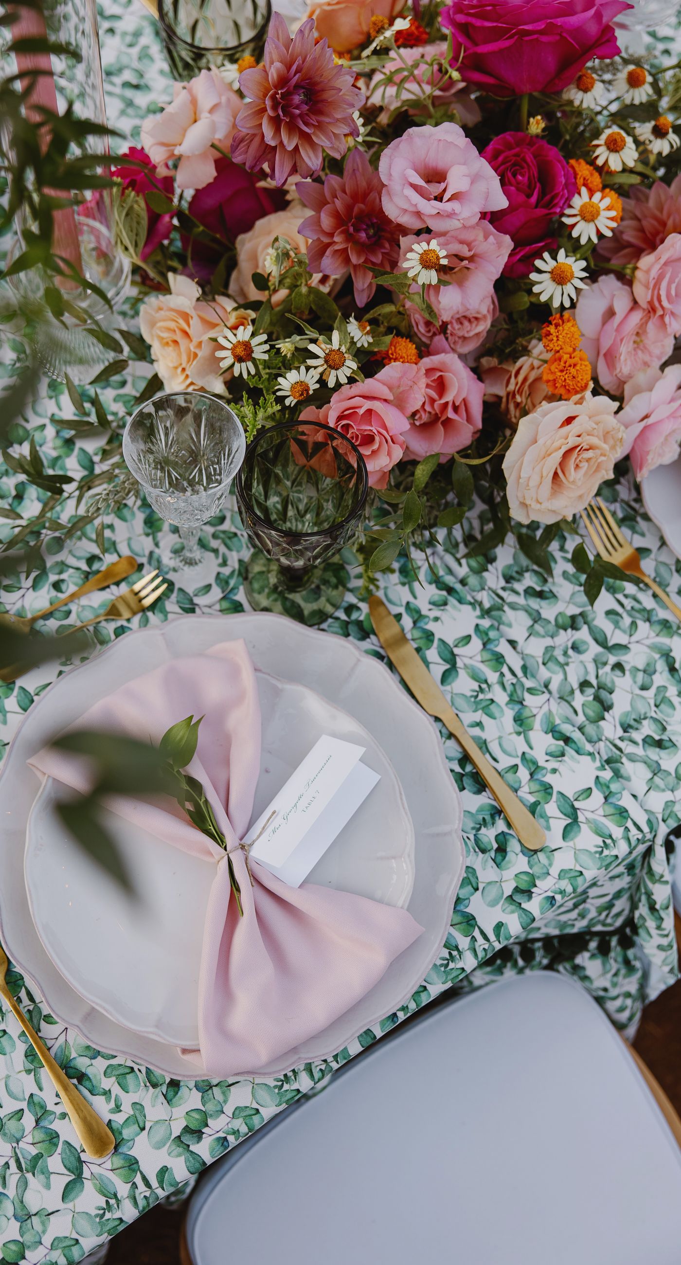 Where Celebration Meets Nature - A modern garden wedding with clean lines and a strong sense of a curated dining experience.
Long communal tables set within the vineyard, statement floral arrangements at varying heights, layers of greenery with bold color accents, and warm lighting that carried the atmosphere from day into night. A setting that felt natural yet intentionally designed  contemporary, vibrant, and effortlessly elegant. - Photo 4