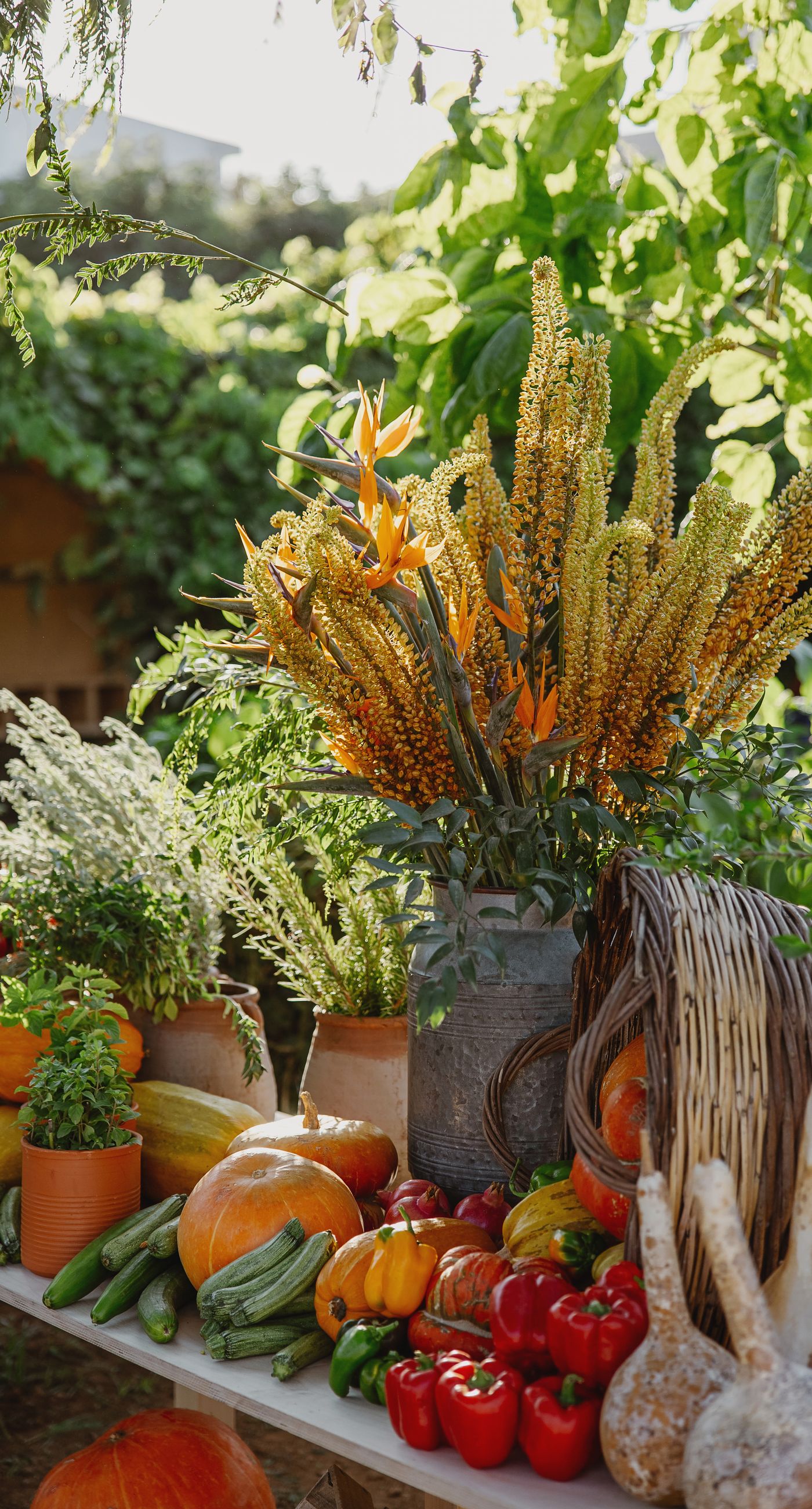 Where Celebration Meets Nature - A modern garden wedding with clean lines and a strong sense of a curated dining experience.
Long communal tables set within the vineyard, statement floral arrangements at varying heights, layers of greenery with bold color accents, and warm lighting that carried the atmosphere from day into night. A setting that felt natural yet intentionally designed  contemporary, vibrant, and effortlessly elegant. - Photo 7
