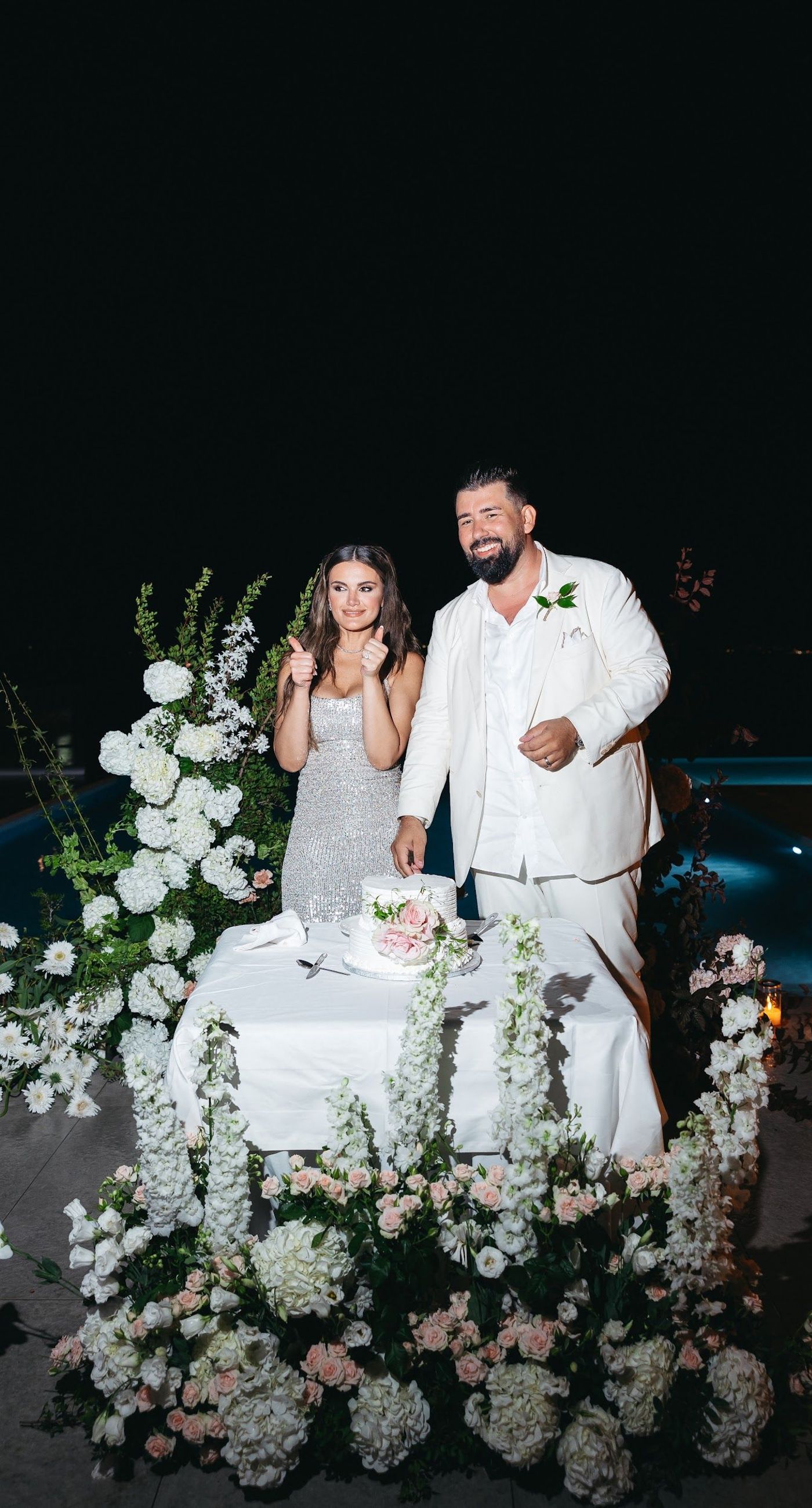 Shay & Vedad - In the serene elegance of a Greek wedding, a mirrored sign stands as a testament to love and artistry. The names "Shay and Vedad" are embossed in sleek white typography, reflecting a moment of intimate celebration bathed in soft, natural light. The minimalist, contemporary aesthetic is accented by subtle greenery, evoking a sense of tranquility and romance amidst the timeless beauty of Crete. The composition captures the harmonious blend of modern elegance with organic details, drawing you into a world where love and nature seamlessly intertwine. - Photo 10