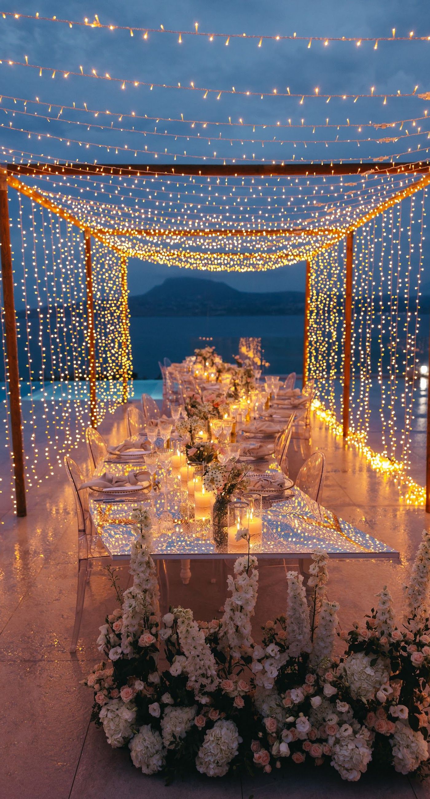 Shay & Vedad - In the serene elegance of a Greek wedding, a mirrored sign stands as a testament to love and artistry. The names "Shay and Vedad" are embossed in sleek white typography, reflecting a moment of intimate celebration bathed in soft, natural light. The minimalist, contemporary aesthetic is accented by subtle greenery, evoking a sense of tranquility and romance amidst the timeless beauty of Crete. The composition captures the harmonious blend of modern elegance with organic details, drawing you into a world where love and nature seamlessly intertwine. - Photo 8