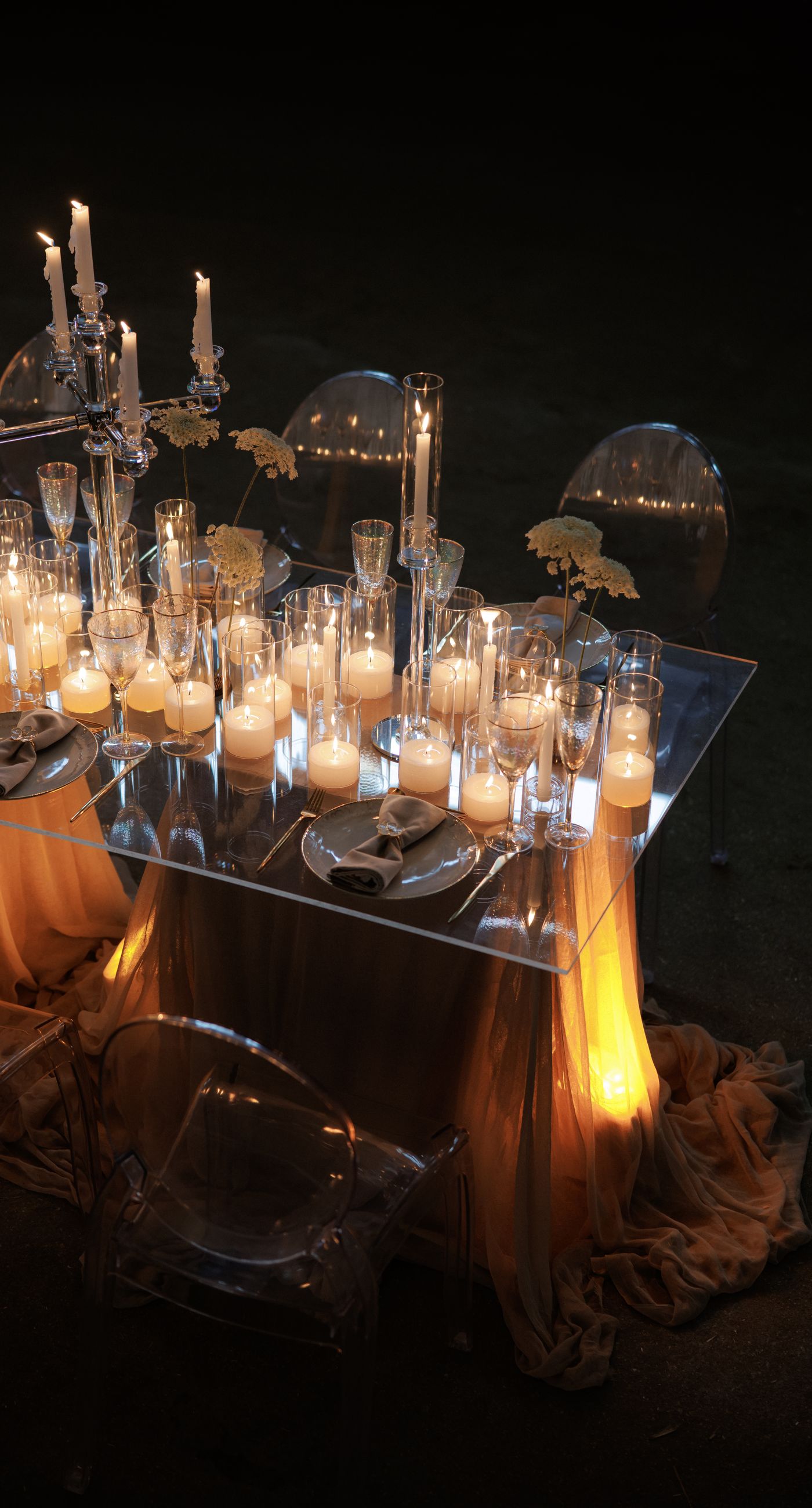 The Extravaganza Flower - Set within an industrial space, this project was conceived as an atmospheric dining experience where light and form take center stage. A sculptural, suspended installation “blooms” above the table, creating depth and scenography, while a candlelit setup adds warmth and intimacy. Clean lines, transparent materials, and subtle florals complete a design that goes beyond decoration it is installation art with emotion. - Photo 7